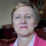 Woman with short hair and a pink jacket