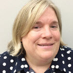 Smiling woman in a polka dot shirt